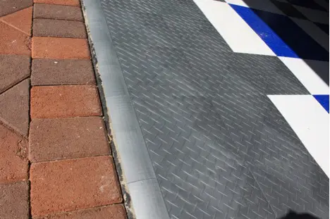 custom-garage-flooring-closet-factory The exterior portion of the garage floor, jointed with the brick driveway