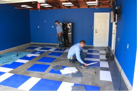 garage flooring installers putting flooring down