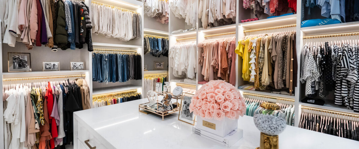 custom white wlk in closet with a white island