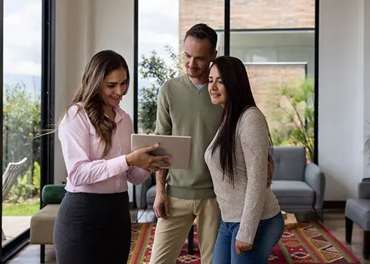 Designer with homeowners reviewing design