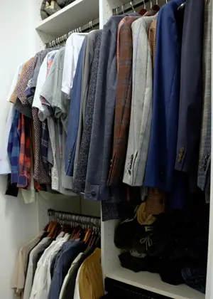 mens clothes organized in closet 