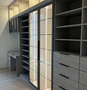 Modern custom closet with sleek dark cabinetry
