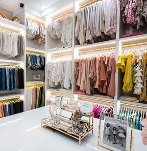 large walk-in closet with triple hanging and island