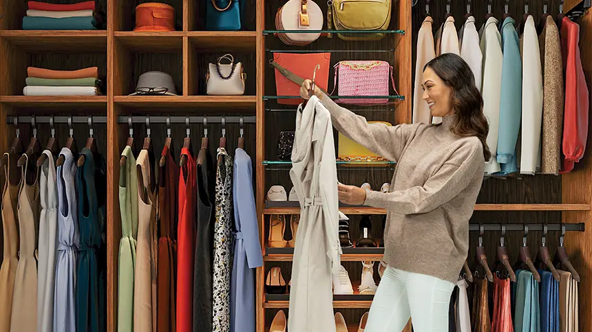 Woman in closet admiring organization of clothes
