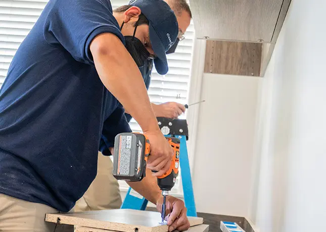 Closet Factory installer working in closet