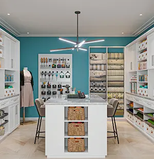 Custom craft room with white built-in cabinetry, center island storage, and a teal accent wall