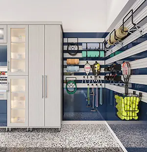 Modern garage storage system with sleek white cabinets and a navy blue slatwall organizing sports equipment, tools, and gear, set above a speckled epoxy floor