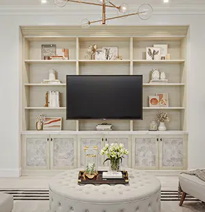 Custom built-in media center with open shelving for décor, a centrally mounted TV, and patterned cabinet fronts below