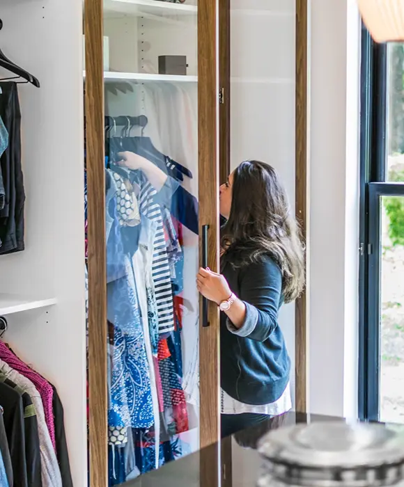 Woman reaching into custom closet
