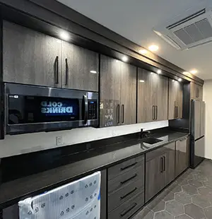 Modern breakroom kitchen with sleek dark wood cabinets