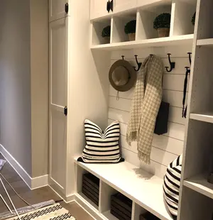 custom white mudroom with clothes and other items