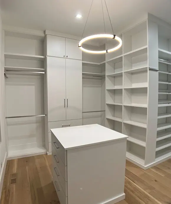 Beautiful white walk in closet with double hanging rods