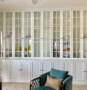 Built-in wall cabinets with glass paneling and custom floor cabinets