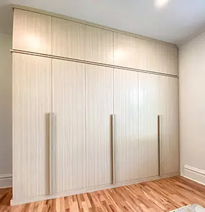 Modern bedroom built-ins; Custom Wood Handles; Wood-Tone Finish