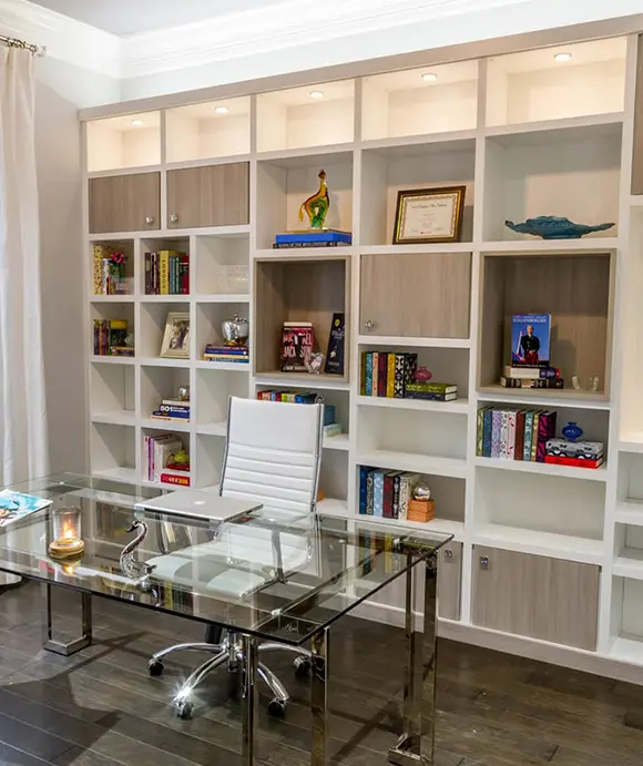 Built in wall shelving system with LED lighting and dual done cabinetry