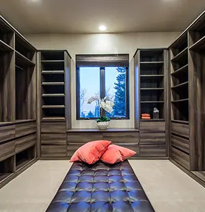 Custom walk in closet with dark woodgrain painted melamine and custom drawers