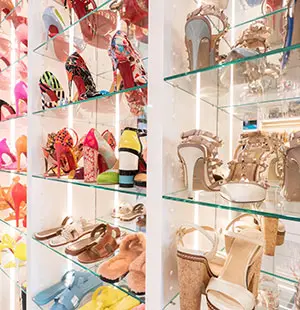 custom shoe shelving units feature glass shelves and mirror backing