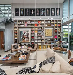 Large shelving unit in the living room displays artwork and books