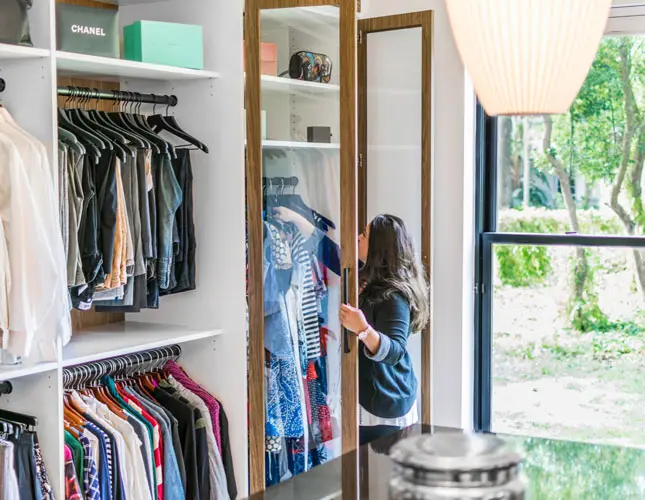 a person looking inside.a closet drawer