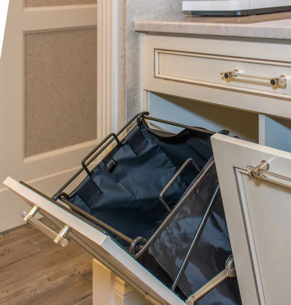 Pull-out fabric hamper built into a cabinet drawer.