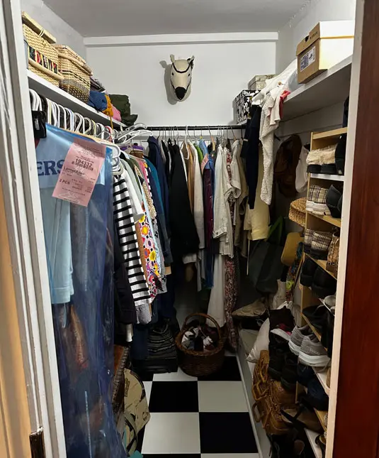 a clutter and unorganized walk-in closet
