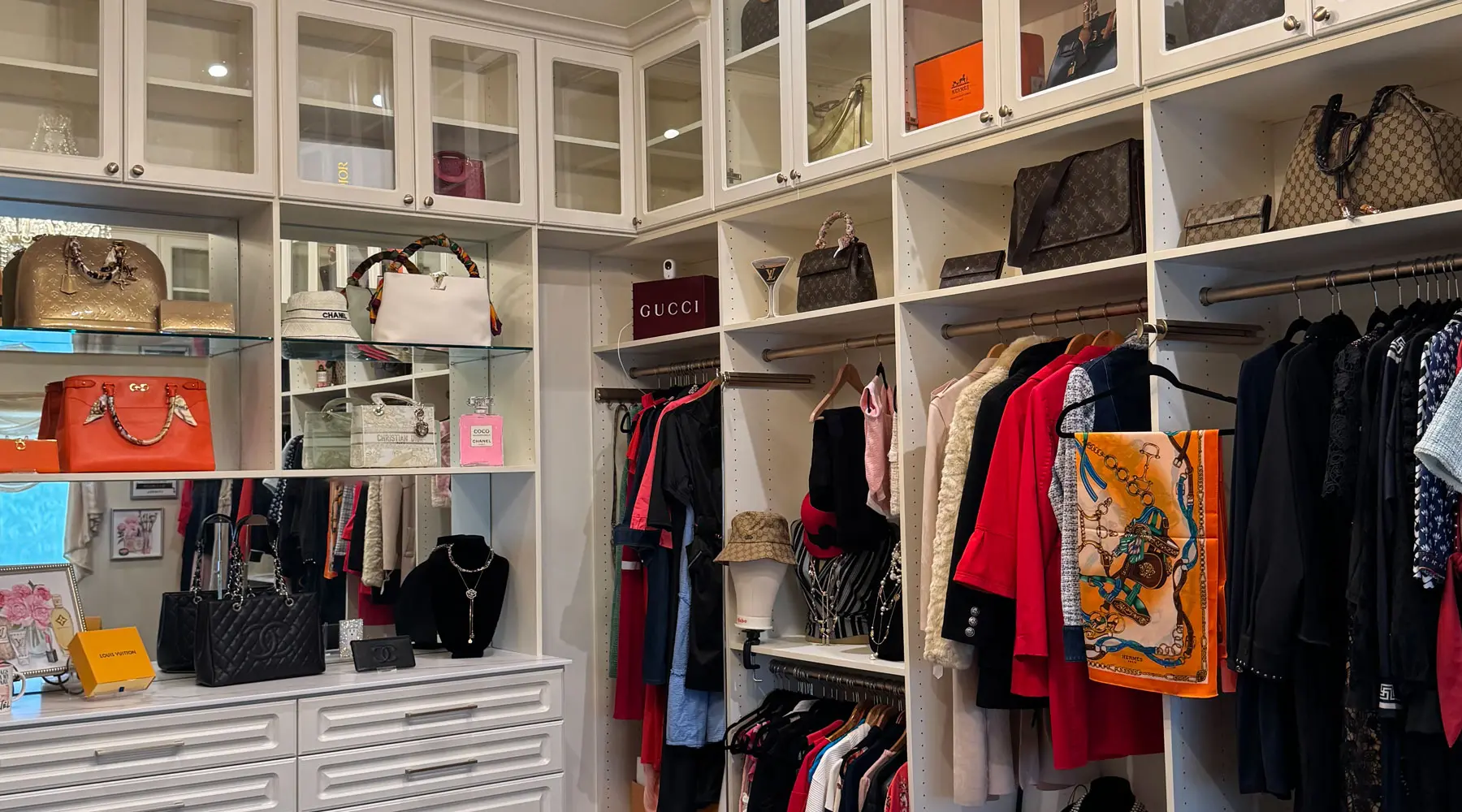custom walk in closet with a mirror 