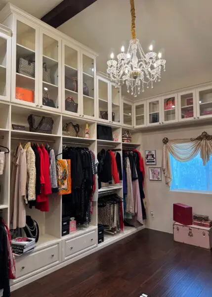 custom walk in closet with hanging sections and drawers