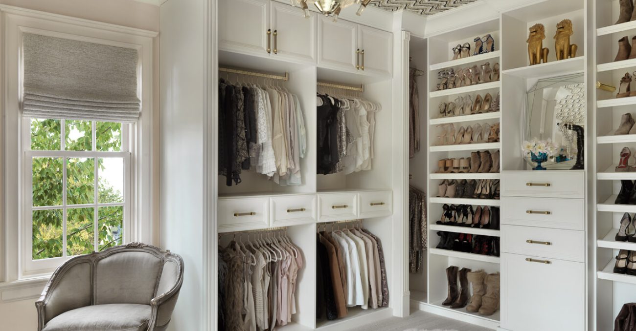 White custom closet shelving, open shelving for shoes, and dual hanging sections for a curated wardrobe display.