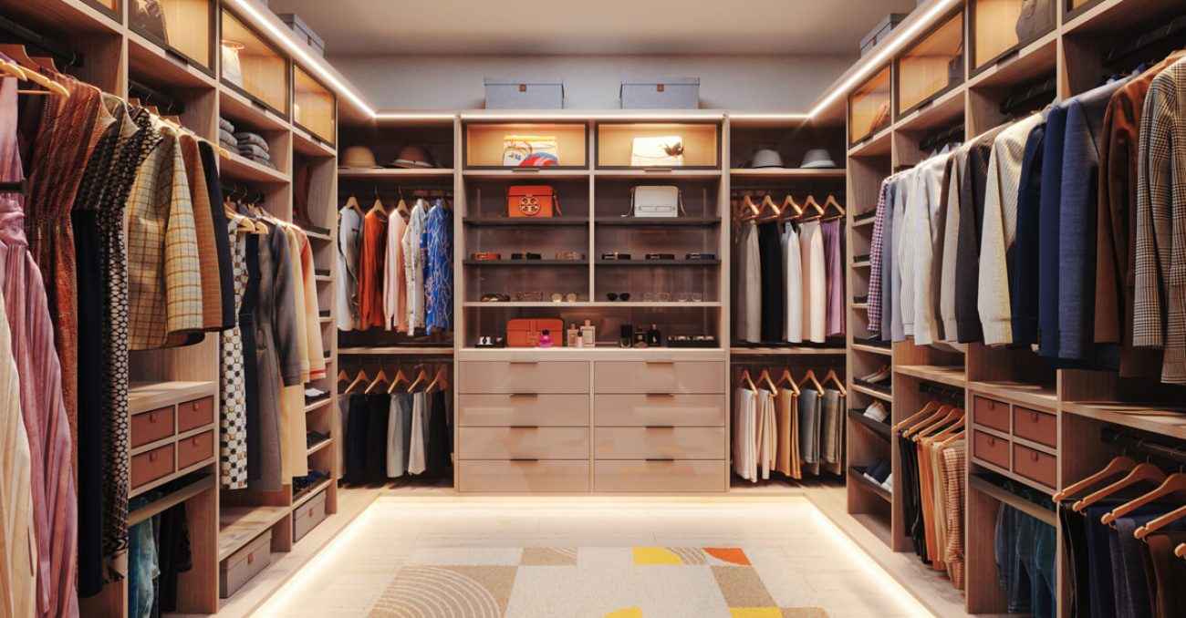 Walk-in closet with Slab drawer fronts, LED-lit upper cubbies, double-hang rods, divided shelving for shoes and accessories, and rich wood grain cabinetry