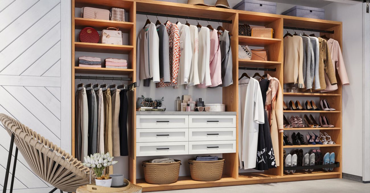 Reach-in closet with Two-tone system with Rustic Cherry structure and White Shaker drawer fronts. Features pull-out pants rack, adjustable shoe shelves, and integrated vanity space.