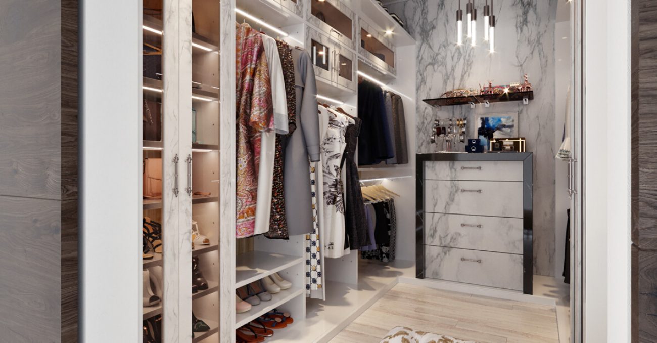 Modern walk-in custom closet with white marble cabinetry