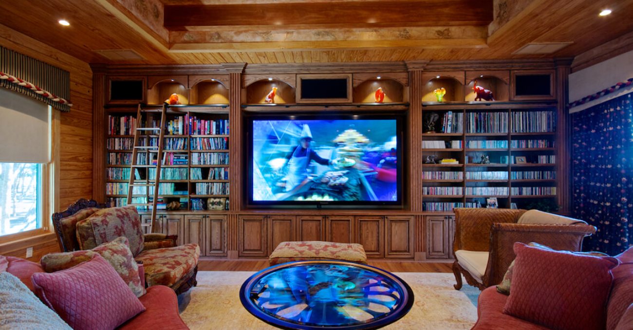 Custom entertainment and media center with book shelves for movies and LED lighting