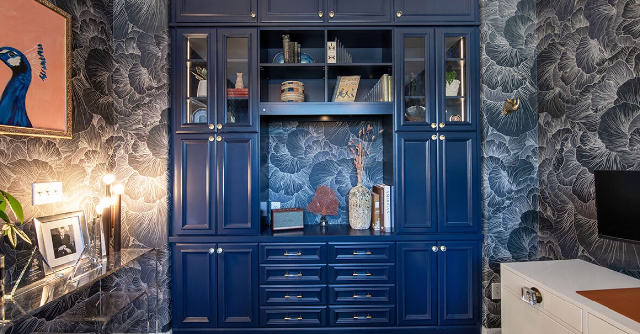 Floor-to-ceiling built-in blue cabinetry in home library