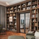 Custom library book shelves with rolling wood ladder and LED lighting