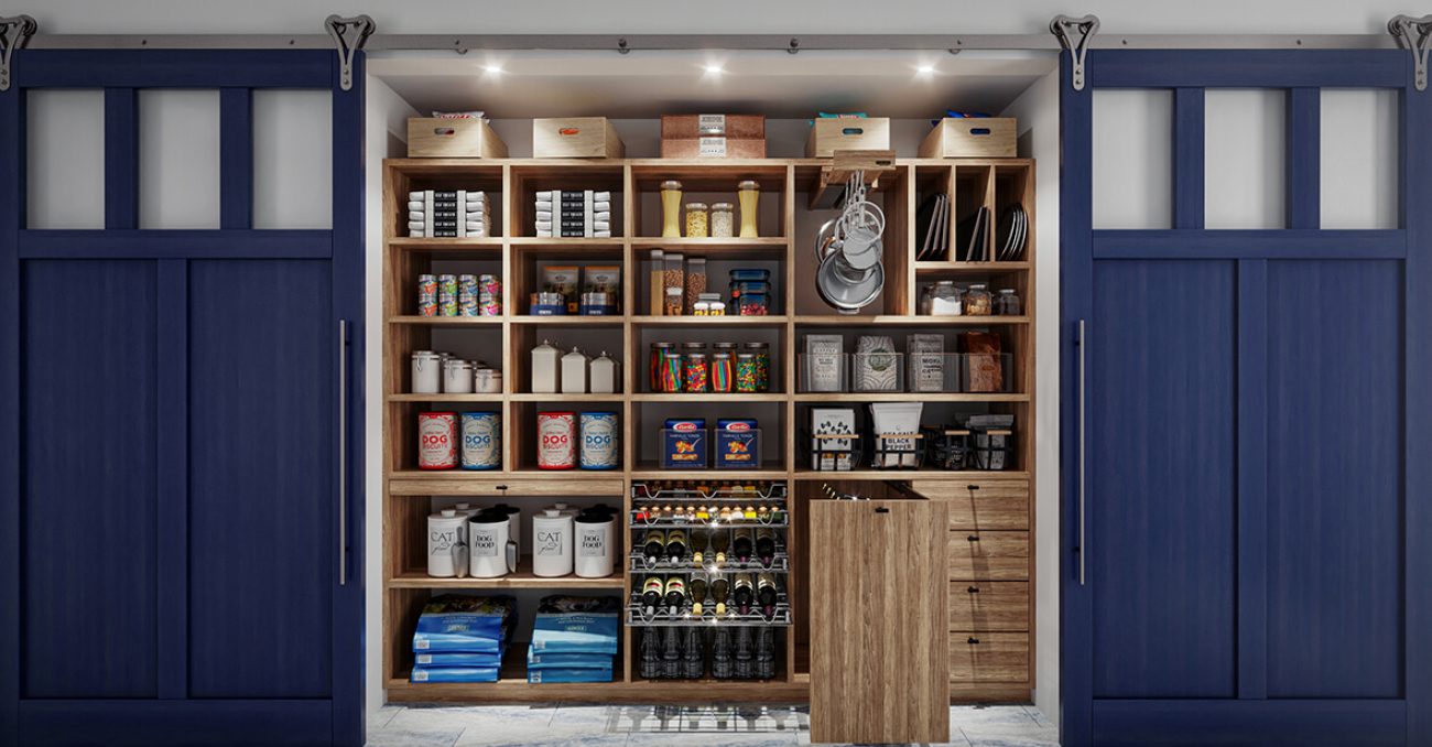 Custom pantry with natural wood shelves, pet food storage, and navy sliding barn doors for concealed organization.