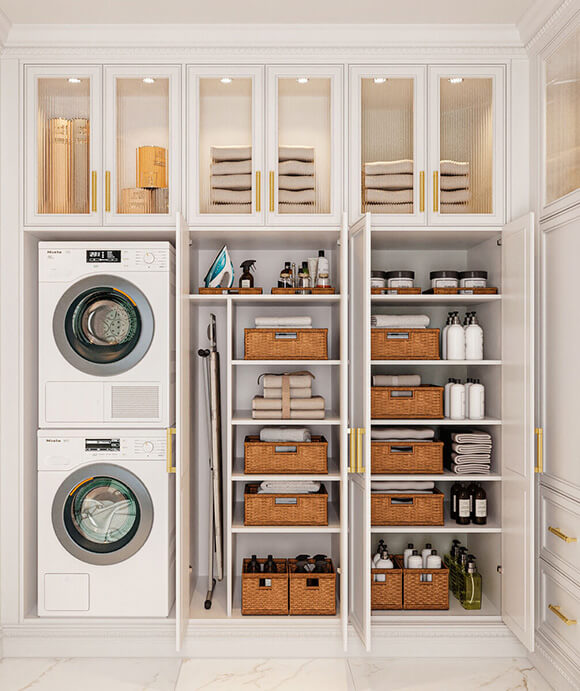 Custom laundry room with stacked washer and dryer, built-in cabinetry, and open shelving featuring woven baskets, towels, and labeled containers