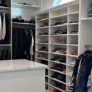 White custom walk in closet with an island