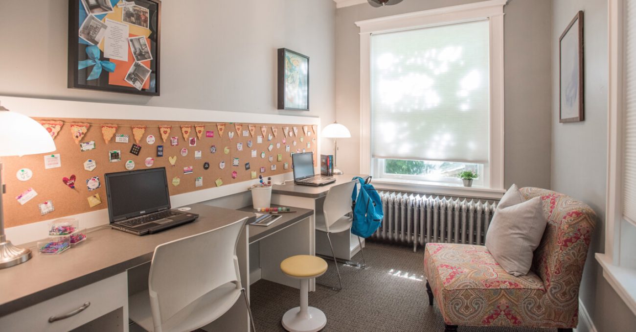Kids media room with cork board wall and built-in desks