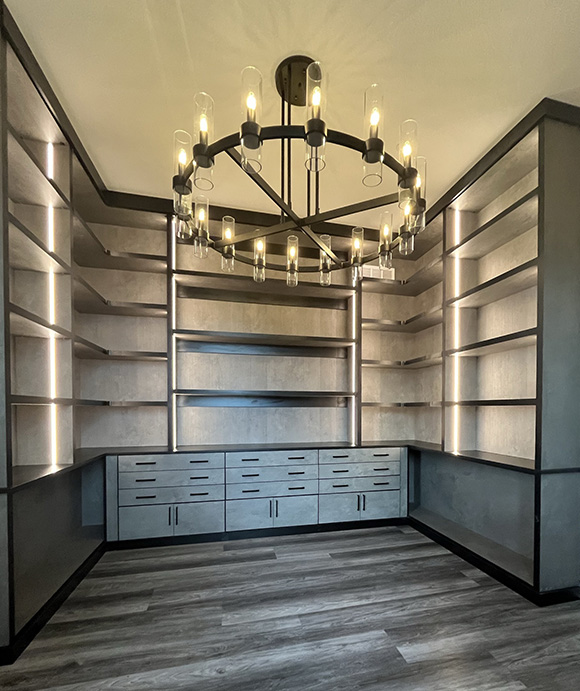 Contemporary walk-in closet with sleek open shelving, underlit LED accent lighting