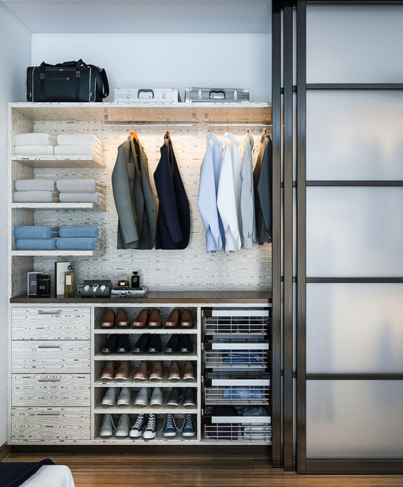Modern reach-in closet with glass-front doors, spotlight-lit shelving, and a mix of hanging sections and drawer storage.