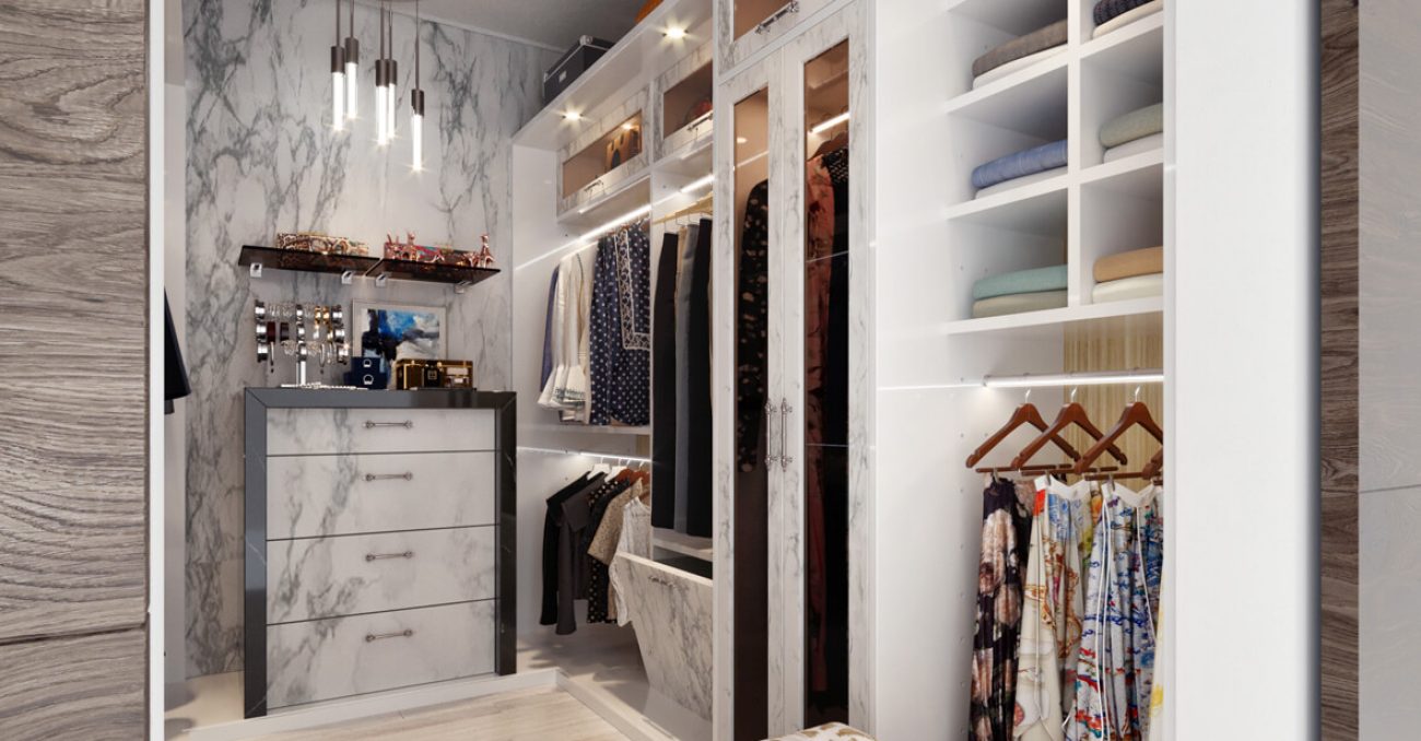 Custom walk-in closet with marble accents and backlit shelving