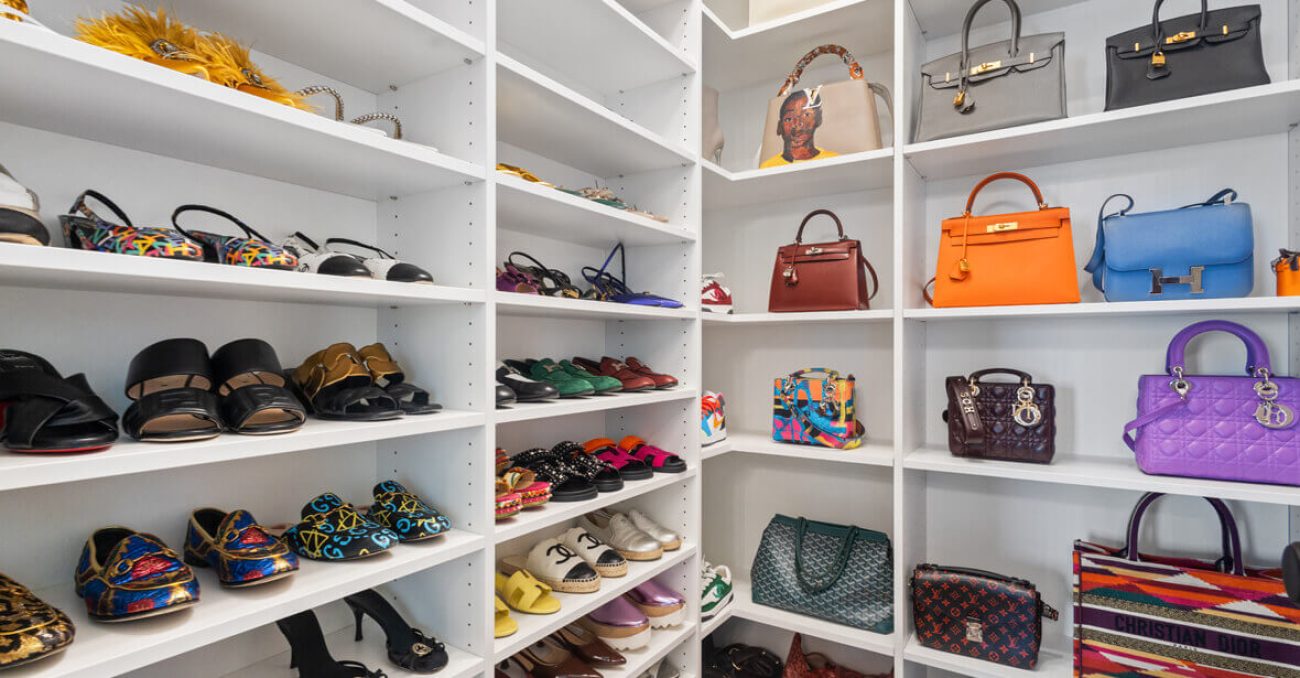 Accessory organization in closet with white gloss shelving for shoes and purses
