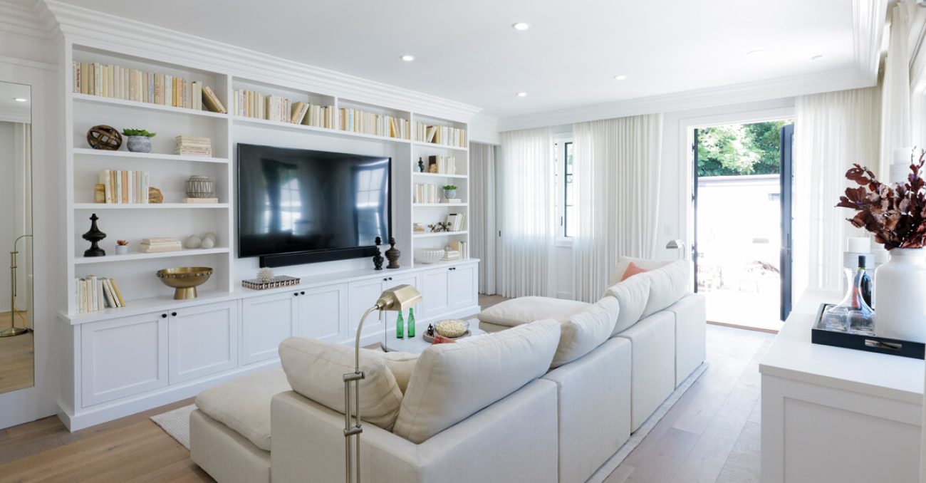 Living room with built in white shaker cabinets and book shelves