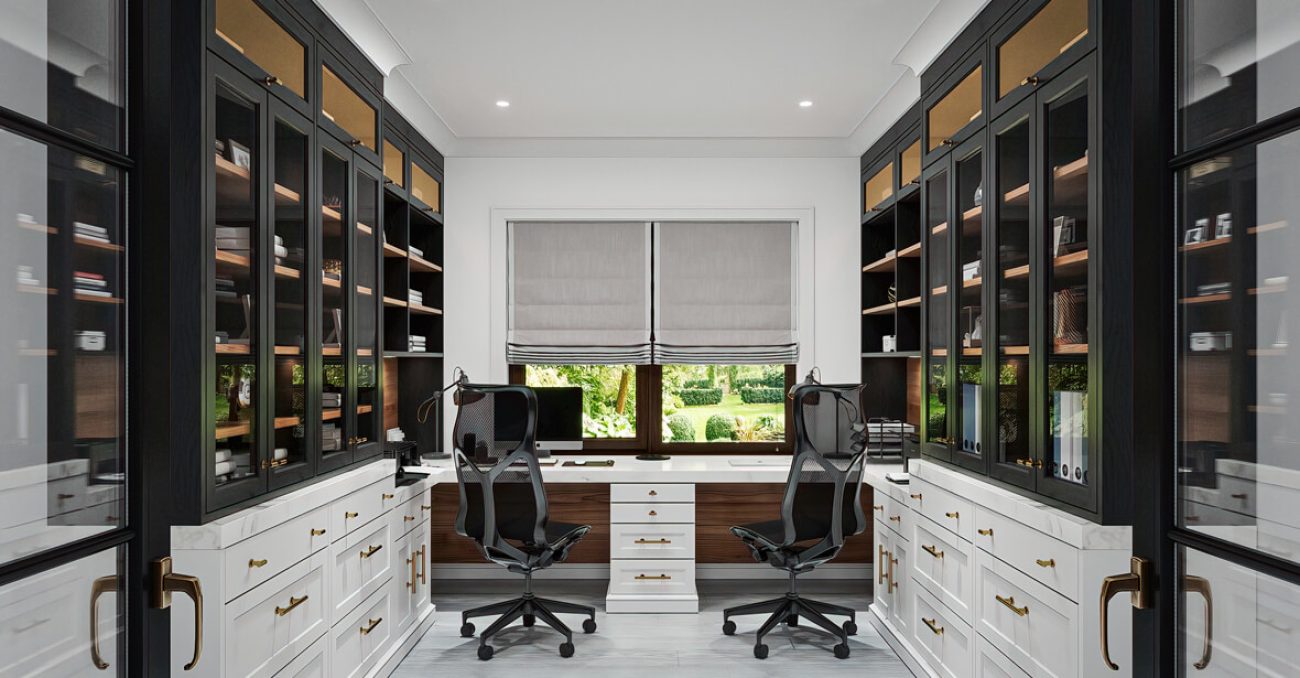 Dual workstation home office with glass-front upper cabinetry, full-extension drawers, overhead cubbies for fabric file boxes, integrated task lighting, and ample desktop space