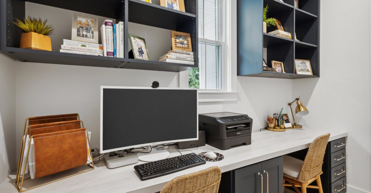 Compact built-in home office with durable worksurface, vertical cubby shelving, and concealed drawers