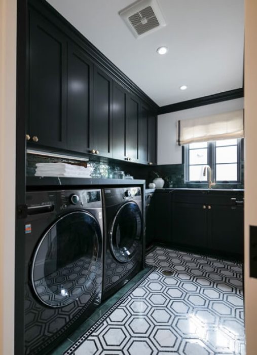Custom laundry room with black high gloss cabinetry and laundry sink