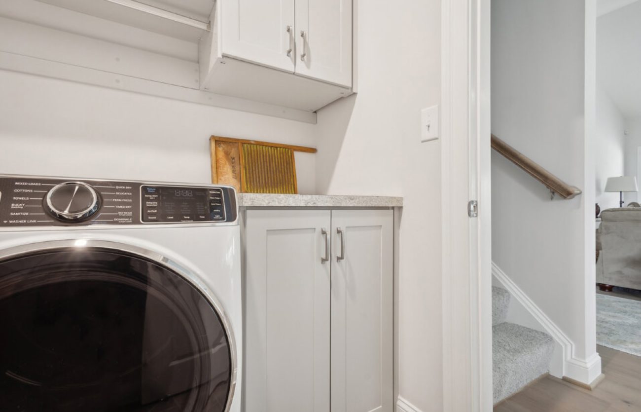 Custom laundry room storage with shaker cabinets