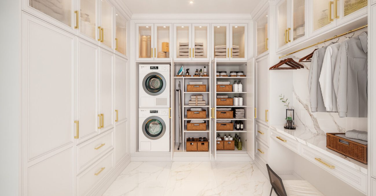 Custom laundry room with gold hanging rod, glass door cabinets, and concealed laundry storage