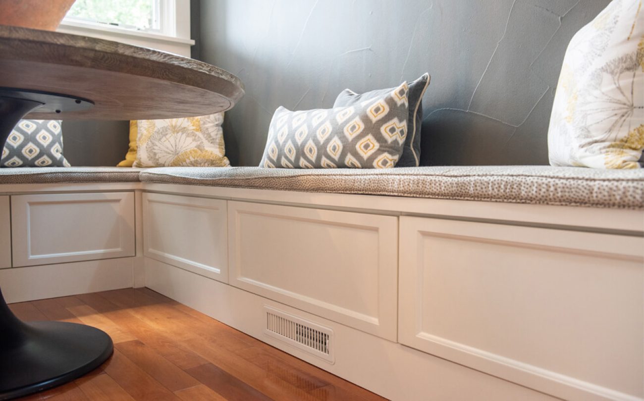 L-shaped breakfast nook with white bench seating and under-bench drawer storage