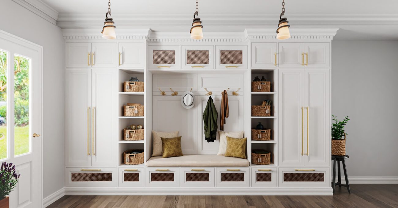 Custom mudroom system with custom cabinetry, crown molding, built-in bench, coat hooks, and cubbies with woven baskets